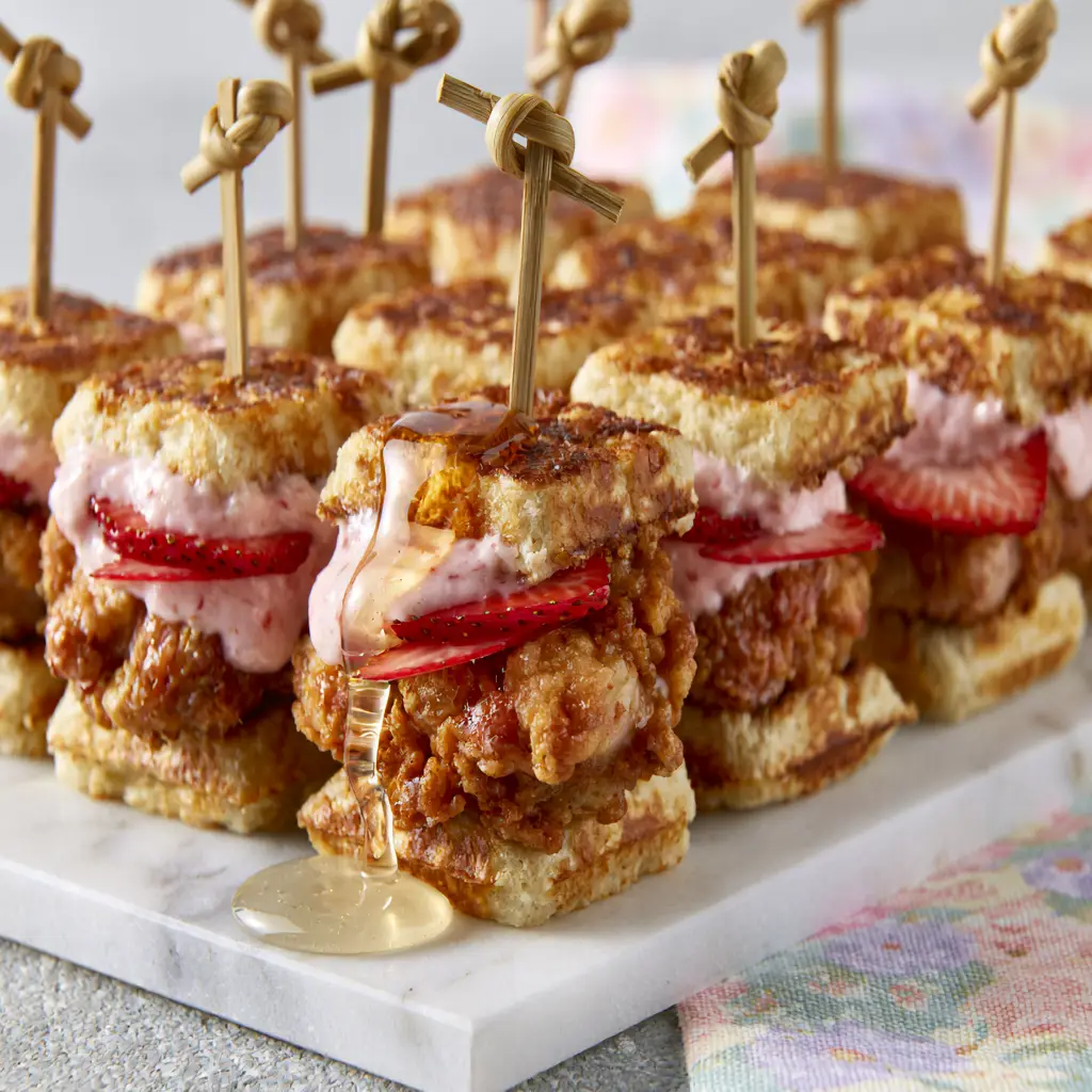 Easter recipes: Mini Buttermilk Waffle & Fried Chicken Sliders with Strawberry Honey Butter 2 Close up of a golden-brown buttermilk waffle slider with crispy fried chicken and melting strawberry butter. (Easter recipes)