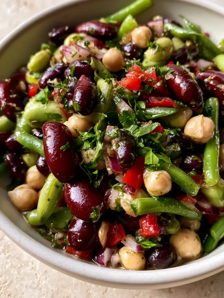 5-Bean Salad Recipe: The Ultimate Zesty & Vibrant Potluck Side 1 Detailed view of glossy kidney beans and firm garbanzo beans in a modern white bowl. (5-Bean Salad)