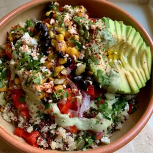Visual layering of red and white quinoa topped with vibrant red peppers and glossy black beans for salade de quinoa mexicaine.